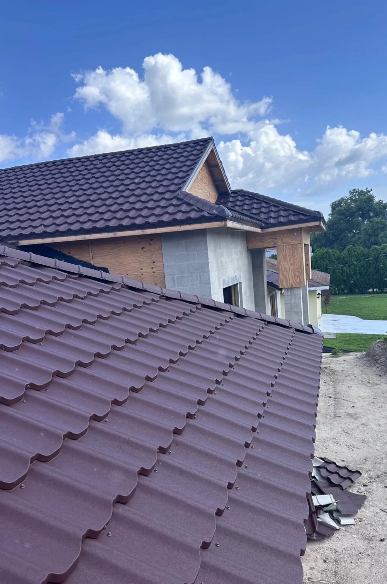 Residential home construction with metal roof installation