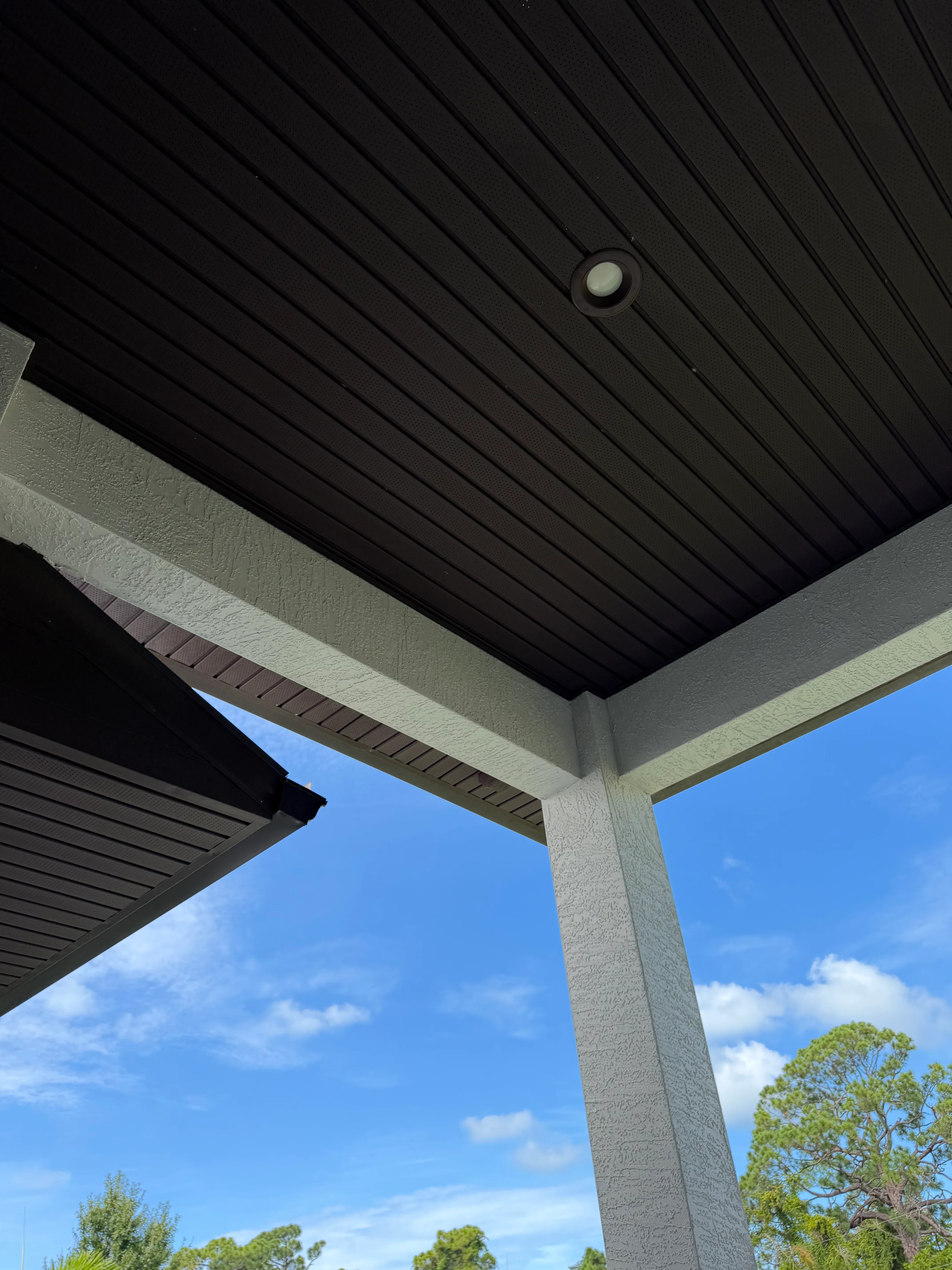 Modern black pergola with concrete columns