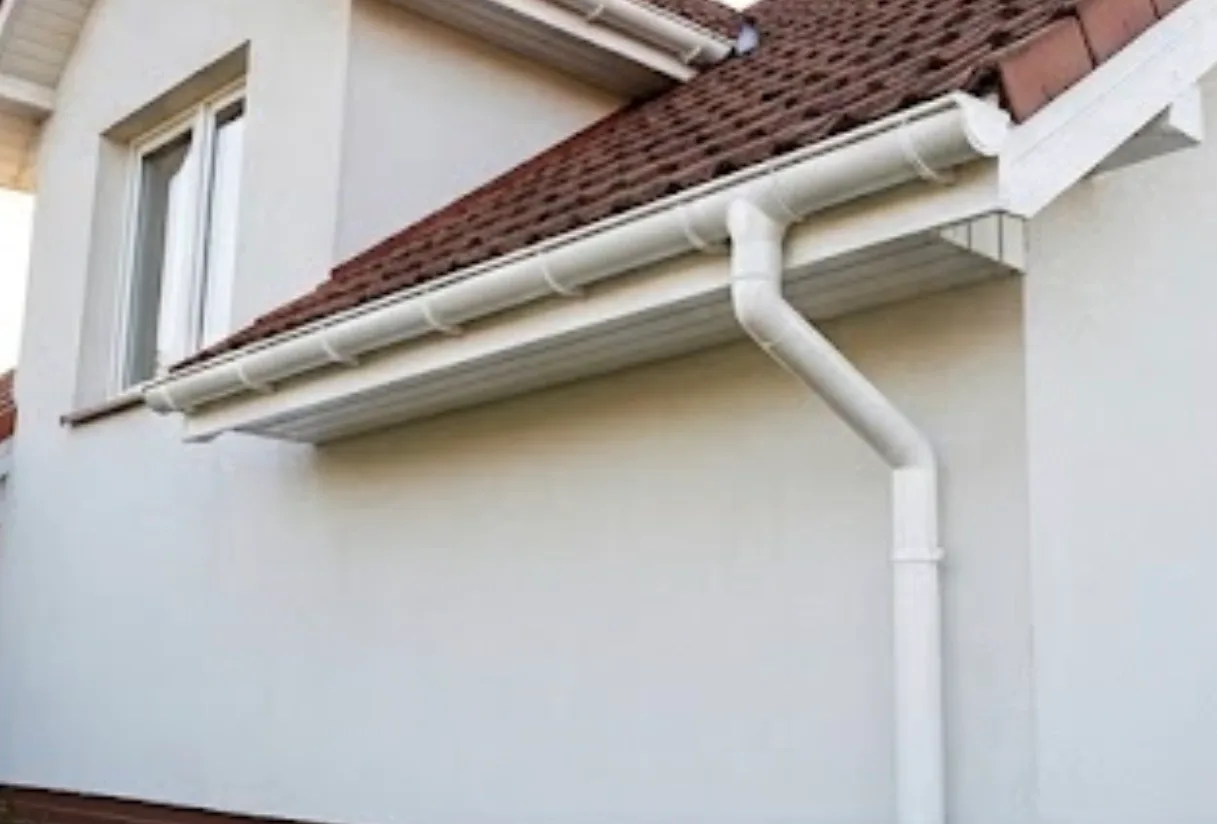 White seamless gutter and soffit installation on residential home with tile roof