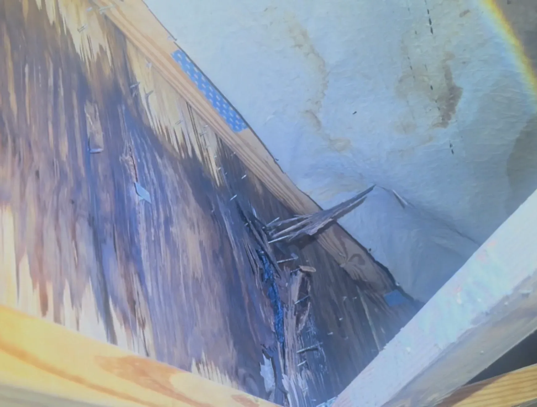 Roof replacement work in progress showing plywood sheathing and roofing materials during residential roof repair project