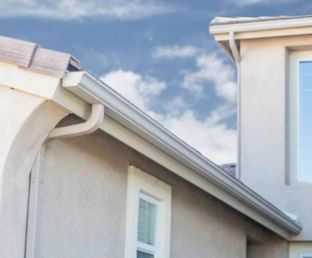 Seamless gutter system installed along residential roof edge with fascia and downspout integration
