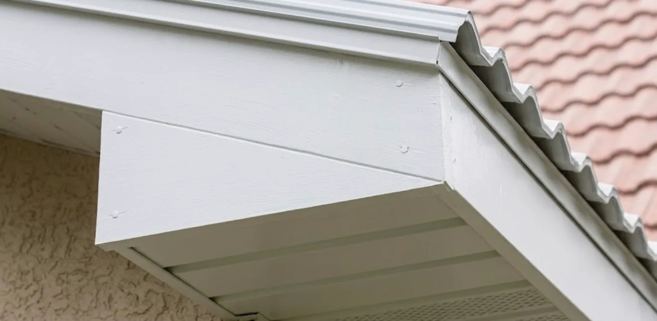 Installed aluminum soffit and white fascia trim at residential roof eave and corner detail