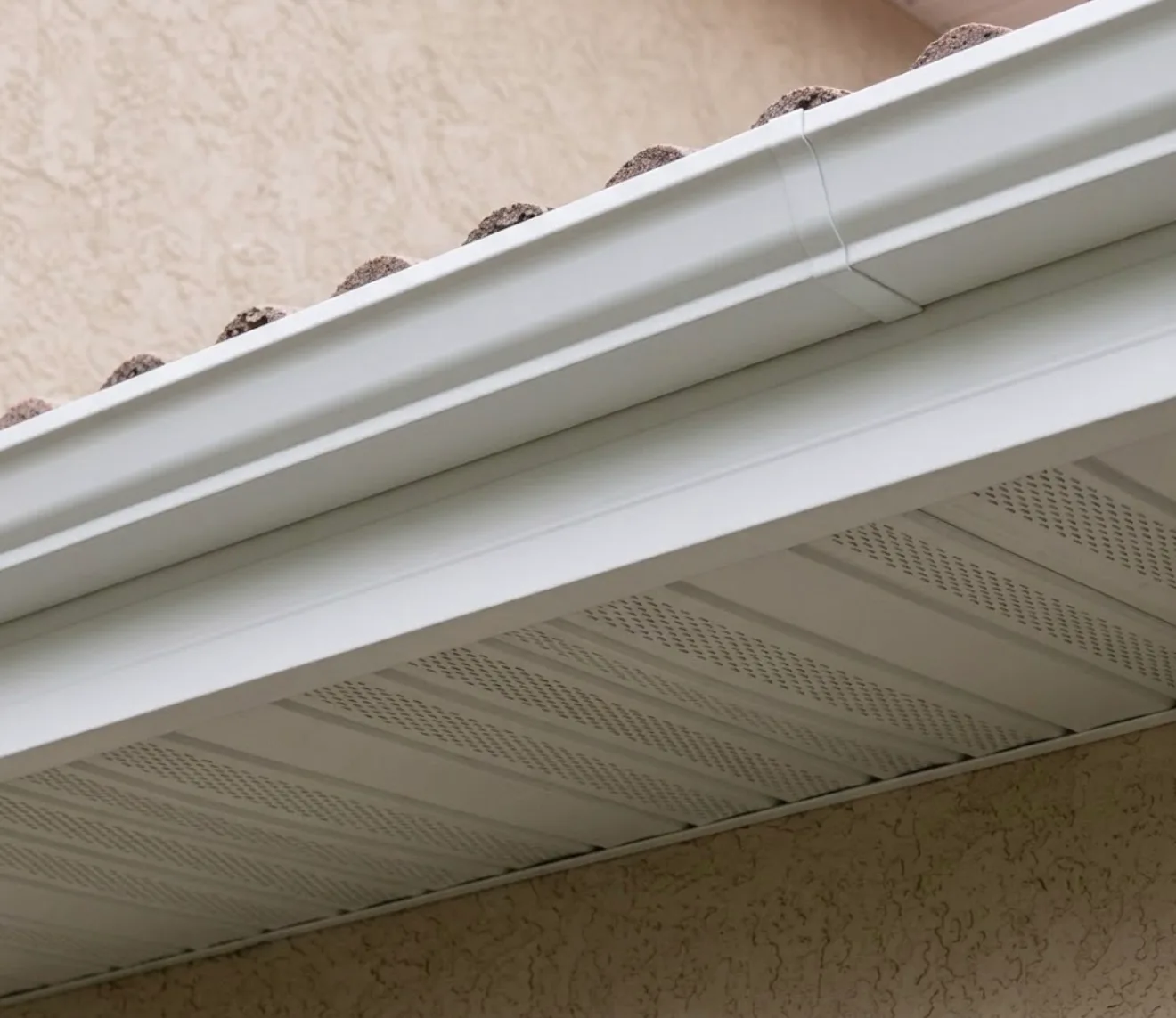 New white aluminum soffit and seamless gutter installed on residential home