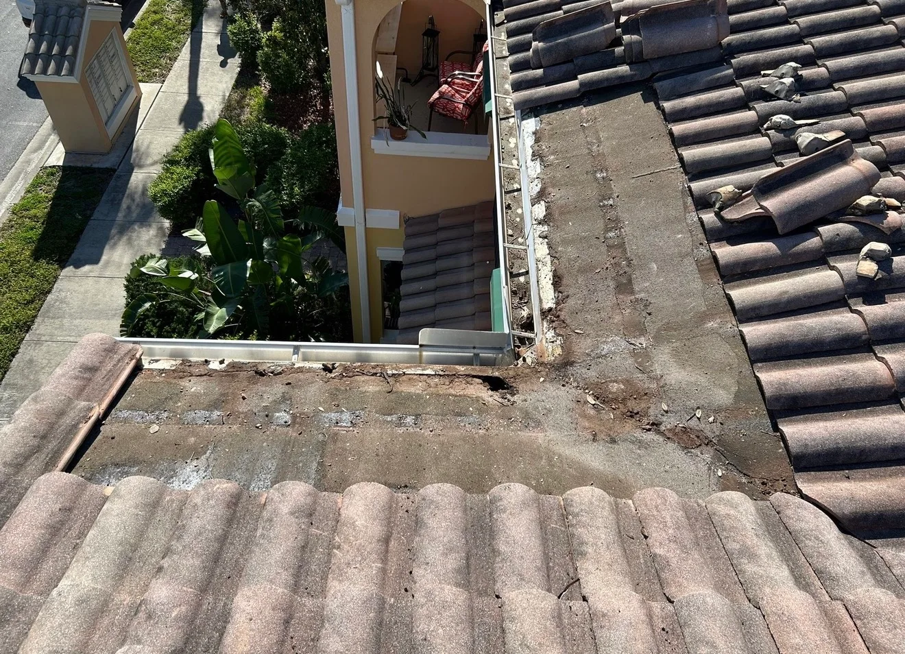Residential tile roof with aged gray ceramic shingles viewed from above