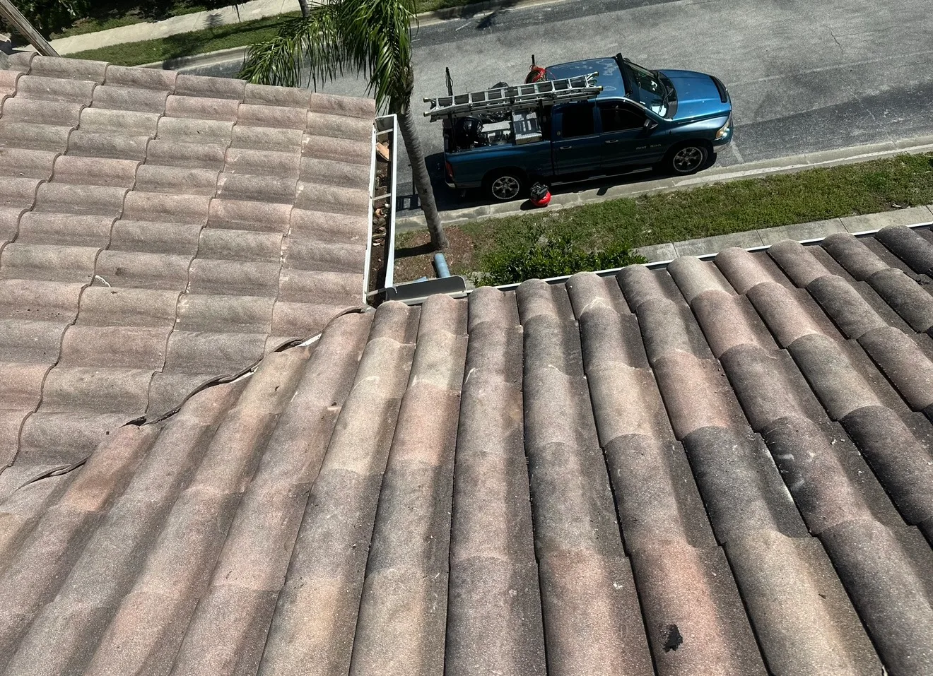 Tile roof close-up showing gray corrugated shingles typical of residential roofing installation