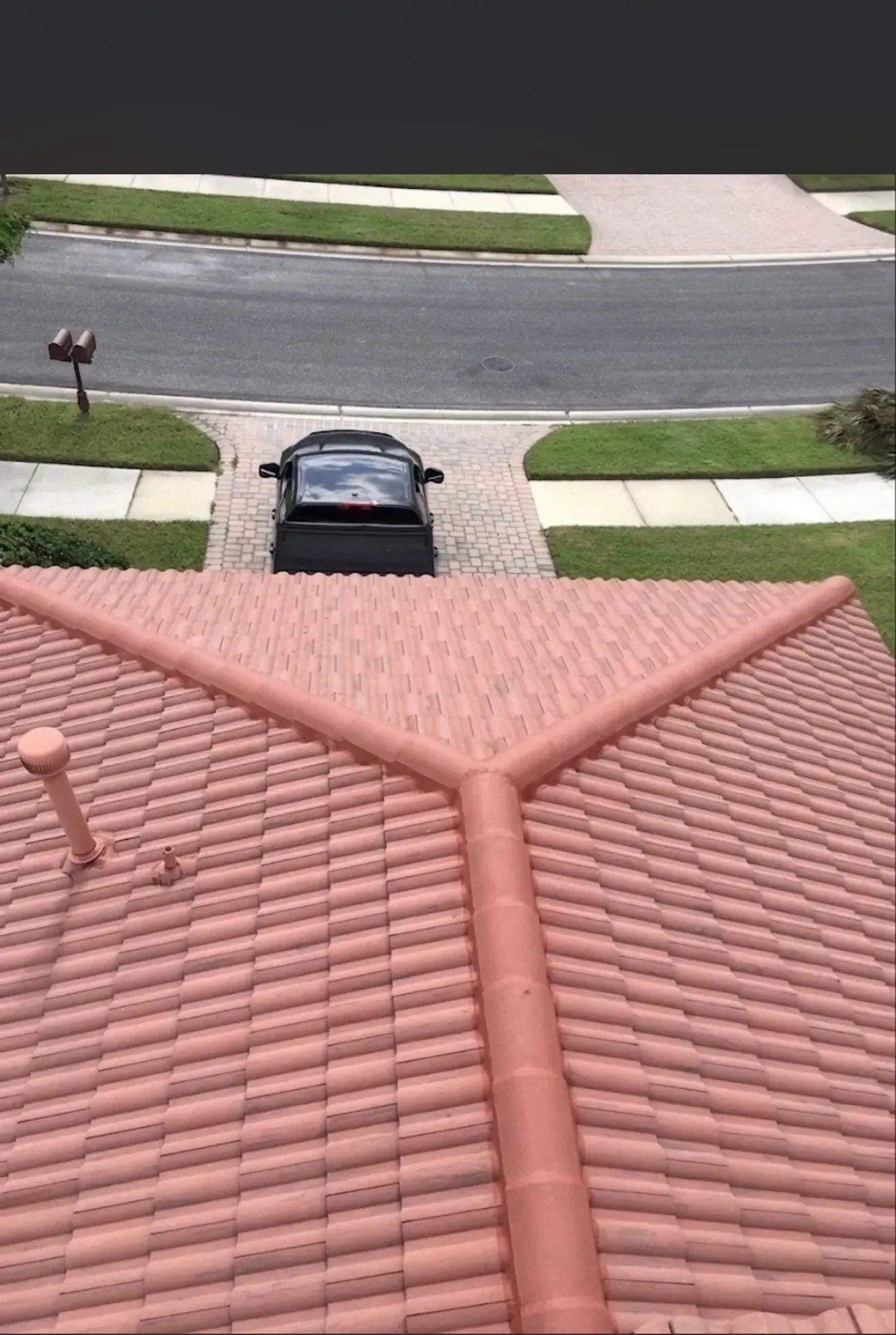 Tile roof installation with clay shingles and ridge caps